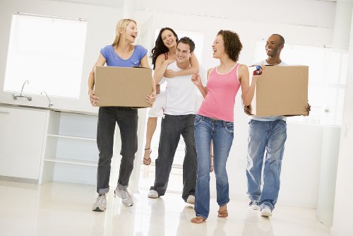 Removals crew managing boxes and furniture in a Mayfair apartment building
