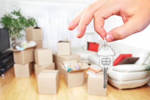 Professional movers carrying office furniture in central London