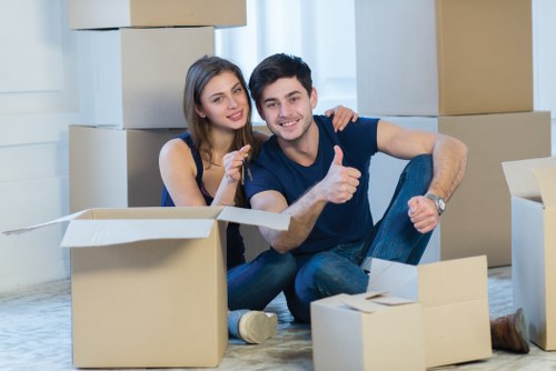 Removal specialists handling office items near a Mayfair street