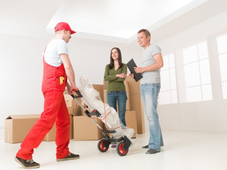 Small moving team handling boxes and household items in central London